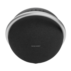 Harman Kardon Onyx Studio 8 speaker in white featuring a sleek circular design with a premium aluminum handle and fabric grille.