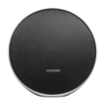 Harman Kardon Onyx Studio 9 in black finish with circular design, fabric grille, and aluminum carry handle placed on a modern wooden shelf